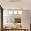 Elegancka lampa wisząca z drewna z ptakami