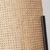 Nowoczesna lampa biurkowa z rattanu i metalu w cylindrycznym kształcie na nóżkach